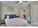 Comfortable bedroom with ceiling fan and a view into the dining room at 1916 Bess Town Rd, Bessemer City, NC 28016