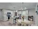 Bright kitchen with white cabinets, stainless steel appliances, kitchen island, and modern lighting at 1916 Bess Town Rd, Bessemer City, NC 28016