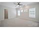 Large, sun-filled bedroom with neutral carpet and trim, and a walk-in closet at 20444 Greenway Heights Dr, Cornelius, NC 28031
