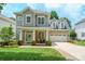 Charming two-story home with inviting front porch, well-manicured lawn and attached two-car garage at 20444 Greenway Heights Dr, Cornelius, NC 28031