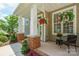 Inviting front porch with brick accents, hanging flower baskets, and a cozy seating area at 20444 Greenway Heights Dr, Cornelius, NC 28031