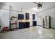 Well organized garage with storage cabinets, work bench and epoxy flooring at 20444 Greenway Heights Dr, Cornelius, NC 28031