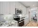 Updated kitchen with stainless appliances, granite counters, and subway tile backsplash at 20444 Greenway Heights Dr, Cornelius, NC 28031