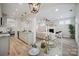 Modern open-concept kitchen flows into living area, featuring granite counters and stainless steel appliances at 20444 Greenway Heights Dr, Cornelius, NC 28031