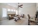 Cozy living room with a ceiling fan, a sofa, accent chair, and natural light at 20444 Greenway Heights Dr, Cornelius, NC 28031