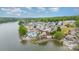 Aerial of waterfront homes nestled in a charming lakeside community, near lush greenery at 216 Grand View Dr, New London, NC 28127