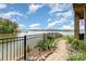Lake view from the backyard with a black metal fence and a stone walkway at 216 Grand View Dr, New London, NC 28127