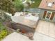Aerial view of backyard with a firepit and patio seating area, overlooking the lake at 216 Grand View Dr, New London, NC 28127