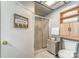 Modern bathroom with a glass-enclosed shower, neutral tones, and convenient towel storage at 216 Grand View Dr, New London, NC 28127