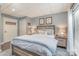 Comfortable bedroom with soft blue bedding, shiplap accent wall, and warm bedside lighting at 216 Grand View Dr, New London, NC 28127