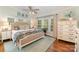 Cozy bedroom filled with natural light, features hardwood floors, a comfortable bed and stylish decor at 216 Grand View Dr, New London, NC 28127