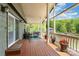 Inviting deck with lake views featuring a seating area and railing with beautiful flower planters at 216 Grand View Dr, New London, NC 28127