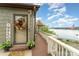 Inviting front porch with a 'Welcome' sign, leading to a scenic walkway and gazebo overlooking the lake at 216 Grand View Dr, New London, NC 28127