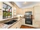 Close-up of kitchen features countertops, undermount sink, modern appliances, and charming decor at 216 Grand View Dr, New London, NC 28127