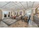Inviting living room with a barrel table and comfortable seating that opens to the outdoor landscape at 216 Grand View Dr, New London, NC 28127