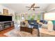 Inviting living room with a cozy fireplace, hardwood floors, and natural light from large windows at 216 Grand View Dr, New London, NC 28127