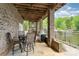 Covered patio with outdoor dining area, grill, and lake views at 216 Grand View Dr, New London, NC 28127