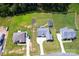 An aerial view of three homes with long driveways and large, green grass yards at 307 Stoneyard Rd, Richfield, NC 28137