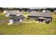 A beautiful backyard with lush green grass, a detached garage, and a patio with an outdoor kitchen at 307 Stoneyard Rd, Richfield, NC 28137