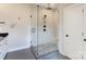 Modern bathroom featuring a glass shower with a built-in seat and sleek fixtures, as well as white door at 307 Stoneyard Rd, Richfield, NC 28137