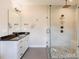 Stylish bathroom featuring a glass-enclosed shower with pebble flooring, and modern fixtures at 307 Stoneyard Rd, Richfield, NC 28137