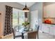 Bright breakfast nook featuring a glass table, modern lighting, and views to the outside at 307 Stoneyard Rd, Richfield, NC 28137