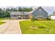 Charming home featuring a well-manicured lawn, stone accents, and a cozy covered entryway at 307 Stoneyard Rd, Richfield, NC 28137