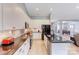 Modern kitchen with white cabinetry, stainless steel appliances, and an open view into the dining and living areas at 307 Stoneyard Rd, Richfield, NC 28137