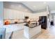 Bright kitchen featuring white cabinets, stainless steel appliances, and a large island with a black countertop at 307 Stoneyard Rd, Richfield, NC 28137