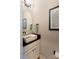 Stylish powder room with a modern vessel sink, unique artwork, and sleek black fixtures at 307 Stoneyard Rd, Richfield, NC 28137