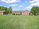 Spacious backyard with a brick house, deck, and plenty of room for outdoor activities at 3206 Basilwood Cir, Monroe, NC 28110