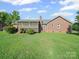 Spacious backyard with a brick house, deck, and plenty of room for outdoor activities at 3206 Basilwood Cir, Monroe, NC 28110