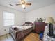 Comfortable bedroom showcasing a window, wood floors, and a classic wooden dresser at 3206 Basilwood Cir, Monroe, NC 28110