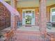 Inviting brick porch with seating area, creating a cozy entryway at 3206 Basilwood Cir, Monroe, NC 28110