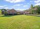 Lovely brick home with well-manicured lawn and extended covered parking area at 3206 Basilwood Cir, Monroe, NC 28110