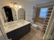 Well-lit bathroom with double sinks, a modern vanity, and a shower/tub combo at 3711 Davis Dr, Charlotte, NC 28270