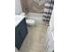 Nicely tiled bathroom with shower/tub combination and blue vanity, blending style with functional design at 3711 Davis Dr, Charlotte, NC 28270