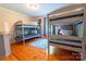 Bright bedroom featuring two sets of gray bunk beds with wood floors and natural light at 3711 Davis Dr, Charlotte, NC 28270