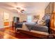 Spacious bedroom with ceiling fan, TV, wood floors, and a luxurious king size bed at 3711 Davis Dr, Charlotte, NC 28270