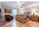 Relaxing bedroom featuring a wooden bed frame, cozy armchair, and beautiful hardwood floors at 3711 Davis Dr, Charlotte, NC 28270