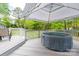 Outdoor hot tub on wooden deck beneath sunshade with lush greenery and a view at 3711 Davis Dr, Charlotte, NC 28270