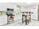 Bright kitchen featuring white cabinets, stainless steel appliances, and a breakfast table at 3711 Davis Dr, Charlotte, NC 28270