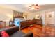 Luxurious main bedroom with hardwood floors, a decorative bed frame, and ample natural light at 3711 Davis Dr, Charlotte, NC 28270