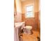 Stylish powder room with decorative tiles, a pedestal sink, and warm lighting at 3711 Davis Dr, Charlotte, NC 28270