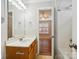 Bright bathroom featuring a vanity with a large mirror and a view into an adjacent bedroom at 3830 Brookchase Ln, Charlotte, NC 28205