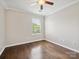 This is a bedroom that has hardwood floors with a ceiling fan and a window at 3830 Brookchase Ln, Charlotte, NC 28205