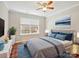 Cozy bedroom featuring neutral walls, hardwood floors, ceiling fan, and ample natural light at 3830 Brookchase Ln, Charlotte, NC 28205