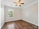 Bedroom with hardwood floors, a ceiling fan, and a window letting in natural light at 3830 Brookchase Ln, Charlotte, NC 28205