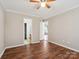 Bedroom with ensuite bathroom featuring hardwood floors, ceiling fan, and ample natural light at 3830 Brookchase Ln, Charlotte, NC 28205
