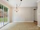 Dining Room with neutral walls, tile floors, and a sliding glass door to the backyard at 3830 Brookchase Ln, Charlotte, NC 28205
